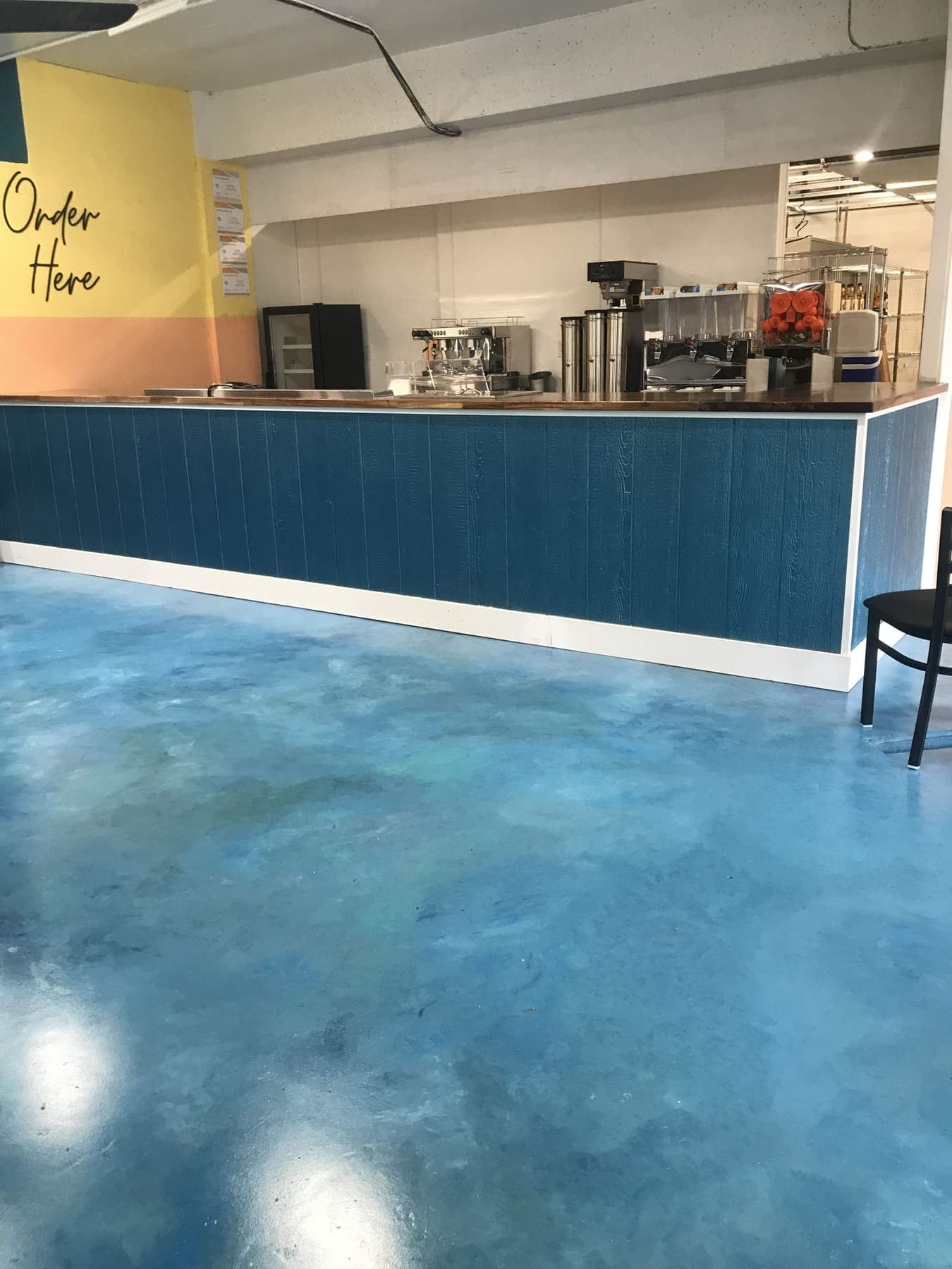 Ocean blue floor in front of the Hungry Honu order counter